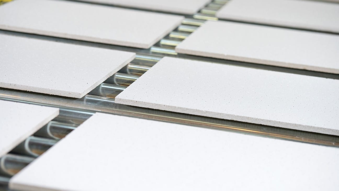 Boards travelling on roller conveyors